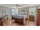 Spacious bedroom with a hardwood floor, large bed, and plenty of natural light at 2401 Home Again Rd, Apopka, FL 32712