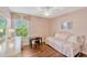A charming bedroom with hardwood floors, a ceiling fan, and a view to the outside through the window at 2401 Home Again Rd, Apopka, FL 32712