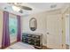 Comfortable bedroom featuring wood floors, a ceiling fan, and a view to the outside through the window at 2401 Home Again Rd, Apopka, FL 32712