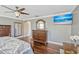 Bright bedroom featuring hardwood floors, large mirror, and neutral color scheme at 2401 Home Again Rd, Apopka, FL 32712