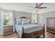 Inviting bedroom showcasing hardwood floors, a large bed, and soft, neutral decor at 2401 Home Again Rd, Apopka, FL 32712