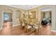 Dining room featuring hardwood floors and elegant dining table and chairs at 2401 Home Again Rd, Apopka, FL 32712