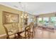 Formal dining room with elegant chandelier, a glass table, and classic furnishings for sophisticated meals at 2401 Home Again Rd, Apopka, FL 32712