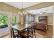 Open dining area with wooden table and backyard access to an outdoor patio and living room at 2401 Home Again Rd, Apopka, FL 32712