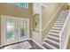 Foyer with hardwood floors, staircase, and elegant double doors leading into the home at 2401 Home Again Rd, Apopka, FL 32712