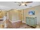 Upstairs hallway with neutral paint, wood floors, and a classic painted green cabinet at 2401 Home Again Rd, Apopka, FL 32712