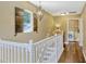 Bright hallway with staircase, wooden shutters, and laundry room with washer and dryer at 2401 Home Again Rd, Apopka, FL 32712