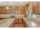 Modern kitchen with granite countertops, stainless steel appliances, and ample cabinet space for culinary enthusiasts at 2401 Home Again Rd, Apopka, FL 32712