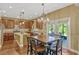 Spacious kitchen with a wooden dining table, stainless steel appliances, and granite countertops at 2401 Home Again Rd, Apopka, FL 32712