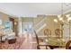 Open-concept living area with hardwood floors, staircase, and elegant dining table at 2401 Home Again Rd, Apopka, FL 32712