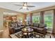 Open-concept living area featuring hardwood floors, two leather sofas, and views into the adjacent kitchen at 2401 Home Again Rd, Apopka, FL 32712