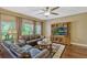 Cozy living room with plush sofas, entertainment center, and ample natural light for comfortable living at 2401 Home Again Rd, Apopka, FL 32712