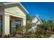 Beautiful street view featuring a light green home with a two-car garage and a manicured front lawn at 2458 Dream Home Ct, St Cloud, FL 34772