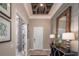 Elegant foyer boasts custom ceiling design, decorative mirror, and stylish console table with lamps at 2458 Dream Home Ct, St Cloud, FL 34772