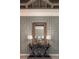 Detailed foyer with paneled walls, oversized mirror, elegant console table, and twin decorative lamps at 2458 Dream Home Ct, St Cloud, FL 34772