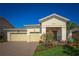 Charming single-story home with a paver driveway, well-manicured lawn, and lush landscaping leading to the front entrance at 2458 Dream Home Ct, St Cloud, FL 34772