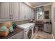 Well-appointed laundry room with ample counter space and modern washer and dryer at 2458 Dream Home Ct, St Cloud, FL 34772