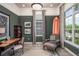 Stylish home office with a surfboard accent, built-in shelves, and ample natural light at 2458 Dream Home Ct, St Cloud, FL 34772