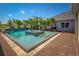 Luxury pool with spa, waterfalls, brick paving, and mature palm trees create a backyard oasis at 2458 Dream Home Ct, St Cloud, FL 34772