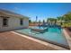 Beautiful backyard pool with integrated water feature and lush landscaping under a bright sky at 2458 Dream Home Ct, St Cloud, FL 34772