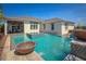 Luxury backyard pool with water features and a view of the elegant home exterior at 2458 Dream Home Ct, St Cloud, FL 34772