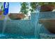 Outdoor mosaic tile pool water feature with stone bowls cascading water into the pool at 2458 Dream Home Ct, St Cloud, FL 34772