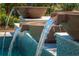 Close-up of decorative bowl fountain, tiled pool waterfall feature at 2458 Dream Home Ct, St Cloud, FL 34772