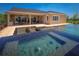 Spacious backyard with a modern pool, covered patio, and manicured lawn, perfect for outdoor living and entertaining at 2460 Dream Home Ct, St Cloud, FL 34772