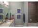 Modern bathroom with double vanity, granite countertop, tiled shower, and decorative accents at 2460 Dream Home Ct, St Cloud, FL 34772