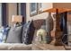 Luxurious bedroom with blue decorative pillows, side table decor, and custom nightstand at 2460 Dream Home Ct, St Cloud, FL 34772