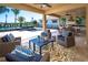 Inviting covered patio with plush seating, outdoor kitchen, and view of the modern pool area for ultimate relaxation at 2460 Dream Home Ct, St Cloud, FL 34772
