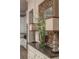 Elegant dining room showcasing a decorative mirror, lamps, a vase of flowers and access to the kitchen at 2460 Dream Home Ct, St Cloud, FL 34772