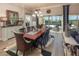 Bright dining room with a long table, modern chandelier, and sliding glass doors to the backyard at 2460 Dream Home Ct, St Cloud, FL 34772