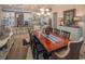 Dining room view showcases an open concept layout and a modern chandelier hanging above the dining table at 2460 Dream Home Ct, St Cloud, FL 34772