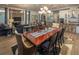 Elegant dining room area with hardwood floors, large windows, and an open view to the living room at 2460 Dream Home Ct, St Cloud, FL 34772