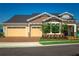 Desirable home featuring a brick driveway, three-car garage, and a covered front porch at 2460 Dream Home Ct, St Cloud, FL 34772