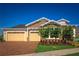 Beautiful single-Gathering home featuring a brick driveway, three-car garage, and manicured landscaping at 2460 Dream Home Ct, St Cloud, FL 34772