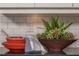 Close-up of a kitchen featuring stylish decor, including stacked bowls, plants, and a white subway tile backsplash at 2460 Dream Home Ct, St Cloud, FL 34772