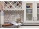 Well-appointed kitchen with white cabinetry, wine rack, glass storage, and elegant decor at 2460 Dream Home Ct, St Cloud, FL 34772