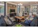 Inviting living room with stylish furnishings, a large television, and access to an open-concept dining area at 2460 Dream Home Ct, St Cloud, FL 34772