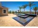 A modern pool area with a tiered water feature, set against a clear blue sky and lush landscaping, promising a serene retreat at 2460 Dream Home Ct, St Cloud, FL 34772