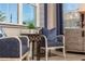 Cozy sitting area with comfortable chairs, a side table, and natural light from a nearby window at 2460 Dream Home Ct, St Cloud, FL 34772