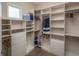 Spacious walk-in closet with custom shelving and ample storage space for clothing and accessories at 2460 Dream Home Ct, St Cloud, FL 34772