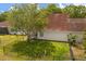 An aerial view of a fenced backyard with lush green grass and a mature tree providing shade in this suburban residential home at 2565 Albion Ave # 2, Orlando, FL 32833