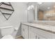 Stylish bathroom featuring a granite double sink, dual mirrors, and a toilet at 2565 Albion Ave # 2, Orlando, FL 32833