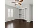 Bedroom showcasing dark wood flooring and a custom closet system at 2565 Albion Ave # 2, Orlando, FL 32833