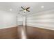 Neutral bedroom featuring wood floors and a horizontally striped accent wall at 2565 Albion Ave # 2, Orlando, FL 32833