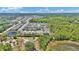 Enjoy this beautiful aerial view of a neighborhood, showcasing tree lined streets, sidewalks, and lush greenery at 2628 Cedar Shake Ct, Oviedo, FL 32765