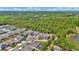 Charming aerial view showcases a residential neighborhood surrounded by lush green trees and a serene pond at 2628 Cedar Shake Ct, Oviedo, FL 32765