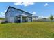 Large backyard with expansive lawn and covered patio area for outdoor enjoyment at 2628 Cedar Shake Ct, Oviedo, FL 32765